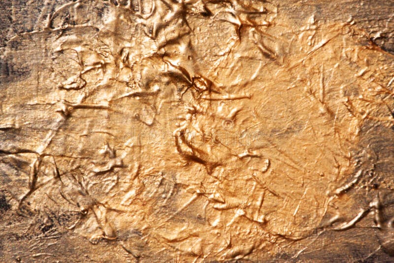 Gold is a bright shiny texture of dried paint. royalty free stock images